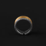 Wooden and metal ring on a black background