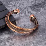 Bronze bracelet on a textured gray surface