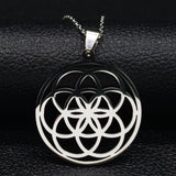 Black and silver pendant on a black leather surface