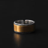 Two-toned ring with gold and silver finish on a black background
